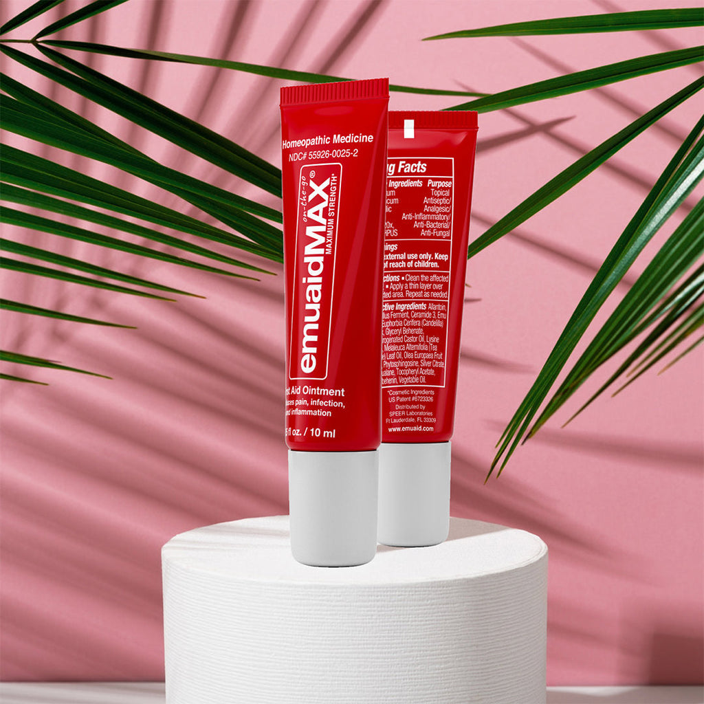 tubetti di pomata emuaidmax rossi su sfondo rosa tubetti di pomata emuaidmax rossi su sfondo rosa